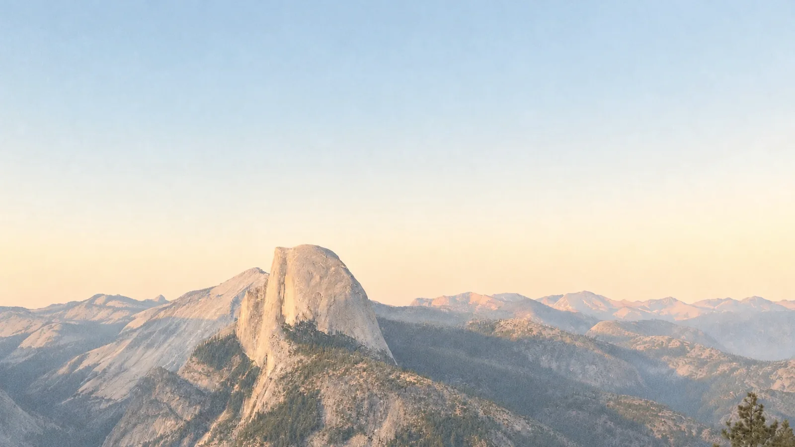 Half Dome in Yosemite at dawn, above the ridges of the valley